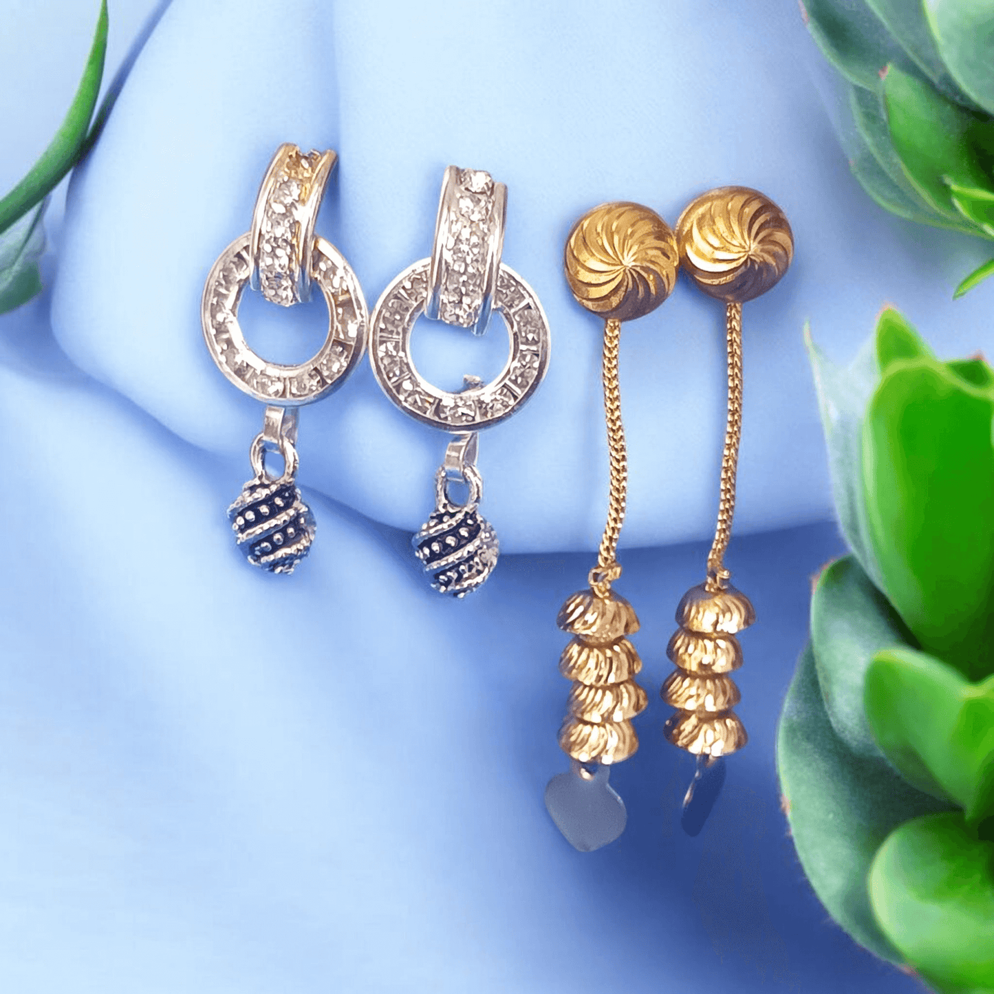 Antique gold long chain dangle earrings with stacked dome beads on a floral background"