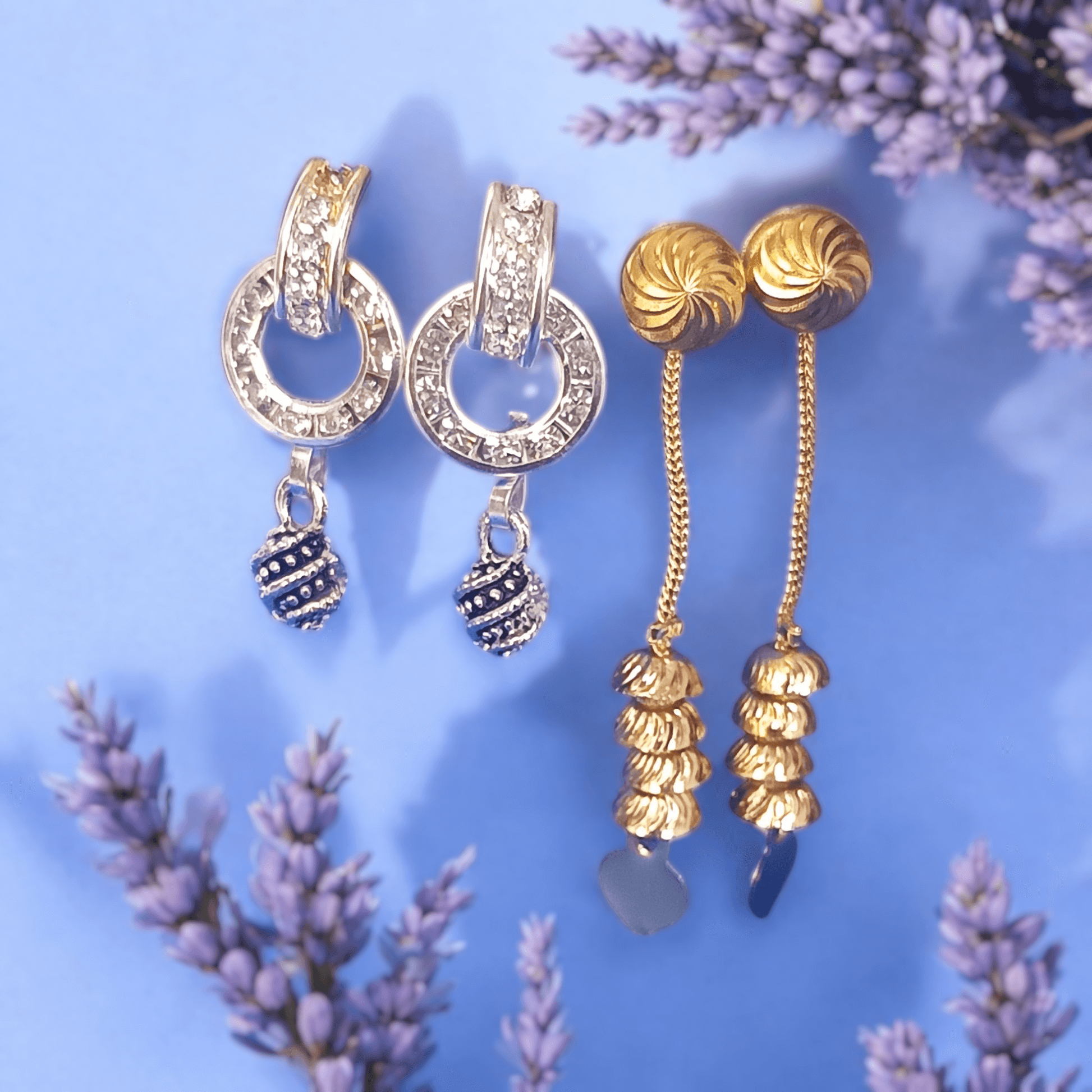 Antique gold long chain dangle earrings with stacked dome beads on a lavender and floral background"